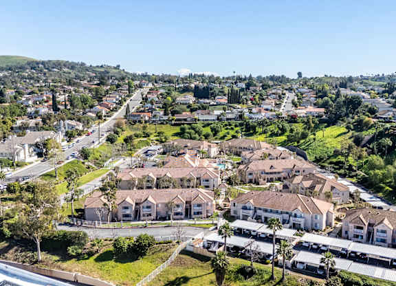 A bird's eye view of a residential area with houses and trees. at Whispering Fountains Diamond Bar, California