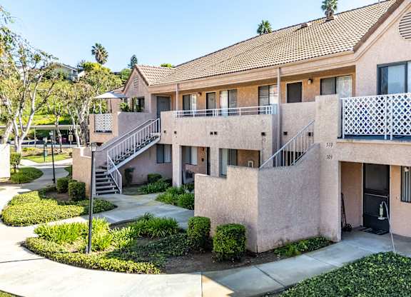A building with a balcony and a staircase leading to the second floor. at Whispering Fountains Diamond Bar, Diamond Bar, CA 91765