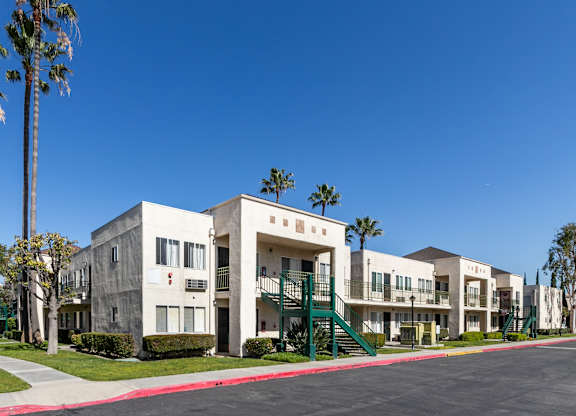 Apartment complex with a red line down the center of the street. at Whispering Fountains Lakewood, Lakewood Bar, 90805