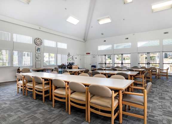 A conference room with a long table and chairs. at Whispering Fountains Lakewood, Lakewood Bar, CA