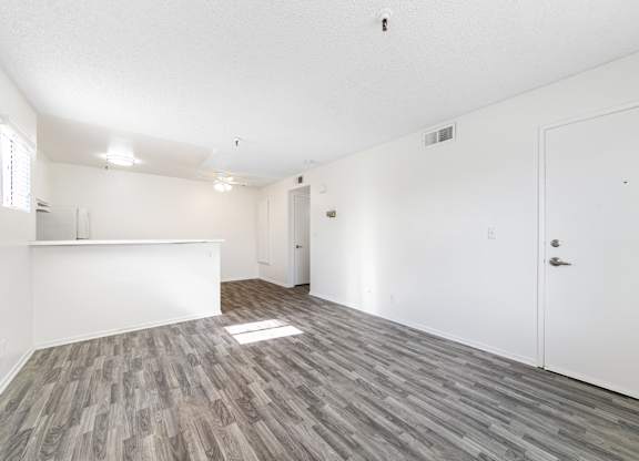 A room with a white ceiling and a grey floor. at Whispering Fountains Lakewood, Lakewood Bar