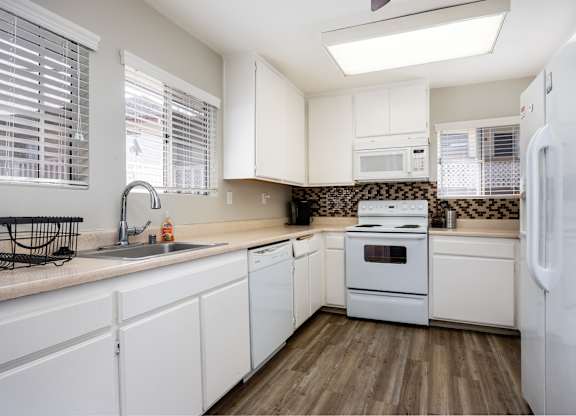 Kitchen with white cabinets and appliances at Whispering Fountains Monrovia, Monrovia, California 