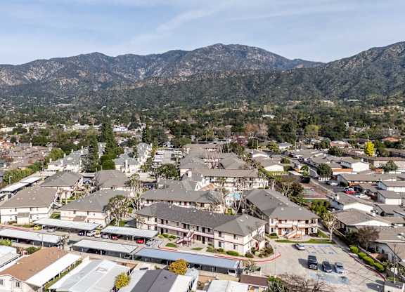 A mountain range is in the background of a town at Whispering Fountains Monrovia, Monrovia, CA, California , 91016