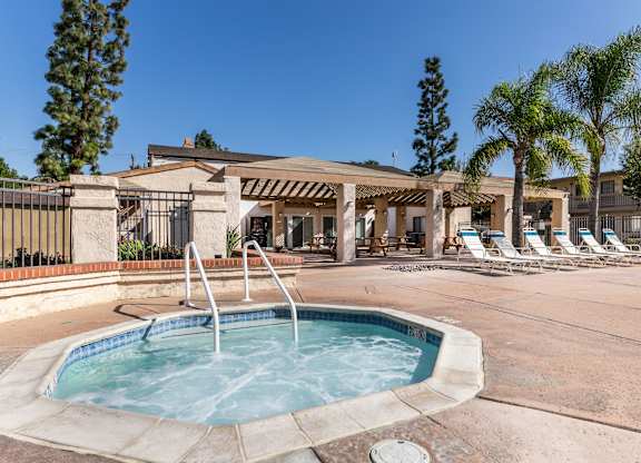 Outdoor hot tub and pool at Whispering Fountains Riverside, Riverside, CA