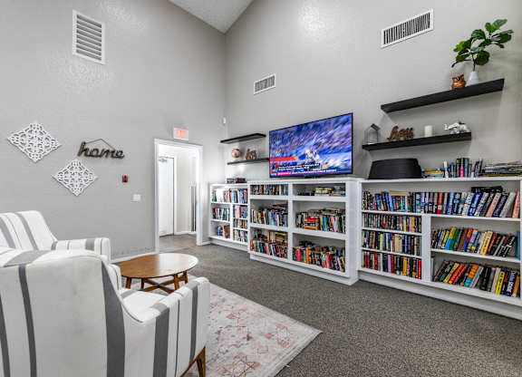 Clubroom with extensive built-in bookshelves at Whispering Fountains Riverside, Riverside, CA, California 