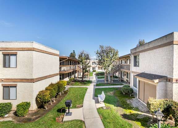 Exterior Walkways with Trees  at Whispering Fountains Riverside, California 