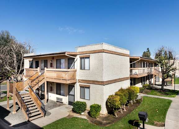 Building with bushes and a sidewalk at Whispering Fountains Riverside, Riverside, CA, California , 92503