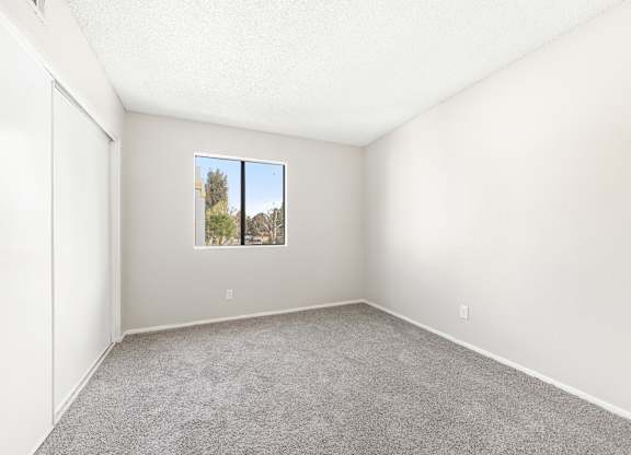 Room with a expansive window and carpeted floor at Whispering Fountains Riverside, California , 92503