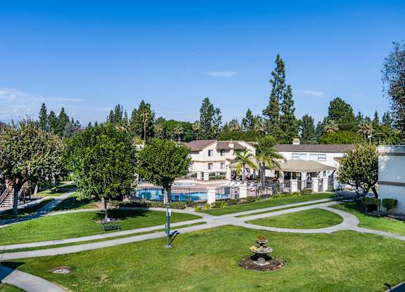 Residential area with a well-maintained lawn and a small garden at Whispering Fountains Riverside, Riverside, CA, 92503
