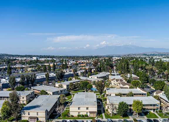 Ariel view of a residential area with houses and buildings at Whispering Fountains Riverside, California 