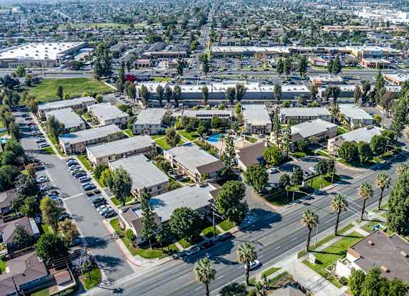 Suburban area with apartment buildings and palm trees at Whispering Fountains Riverside, Riverside, CA, 92503