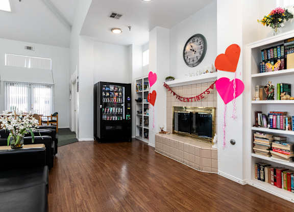 Community lounge with bookshelf at Whispering Fountains Whittier, Whittier, CA, California