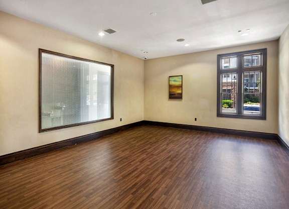 A room with wooden floors and a large mirror on the wall at Vermella Lyndhurst apartments, Lyndhurst 07071
