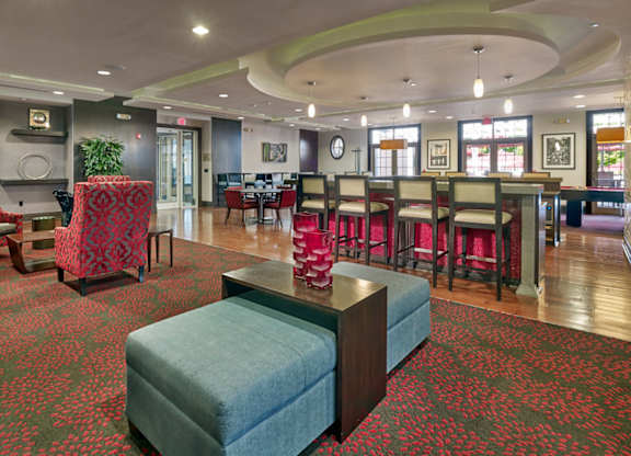 A large room with a green ottoman in the middle of it at Vermella Lyndhurst apartments, Lyndhurst, New Jersey