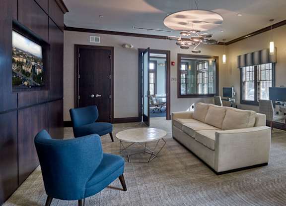 A living room with a blue chair and a white couch at Vermella Lyndhurst apartments, Lyndhurst, NJ, 07071