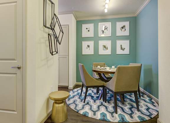 A dining area with a table and chairs.