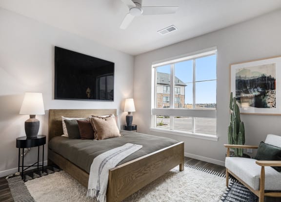 a bedroom with a bed and a large window