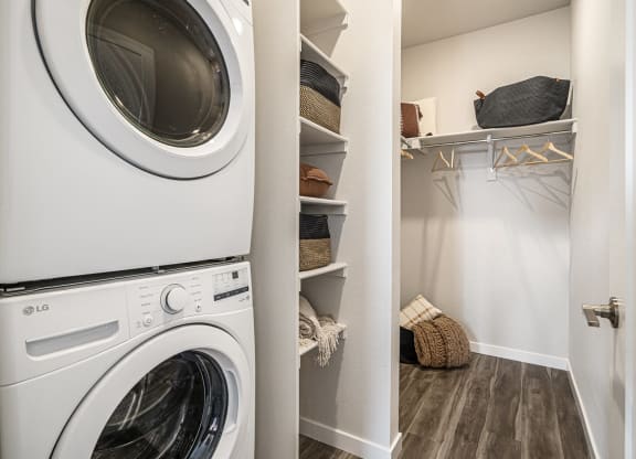 a washer and dryer in a laundry room with a closet