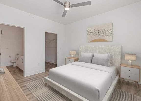 A bedroom with a large bed, a ceiling fan, and a painting on the wall.