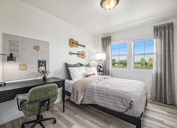 a bedroom with a bed and a desk