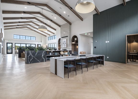 a large room with a table and chairs in the middle of it