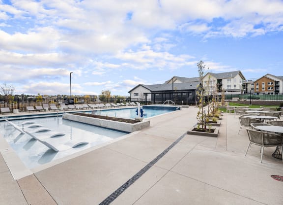 our apartments have a resort style pool with tables and chairs
