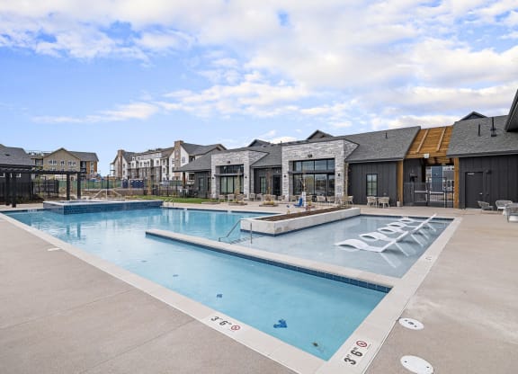 a swimming pool with apartments in the background