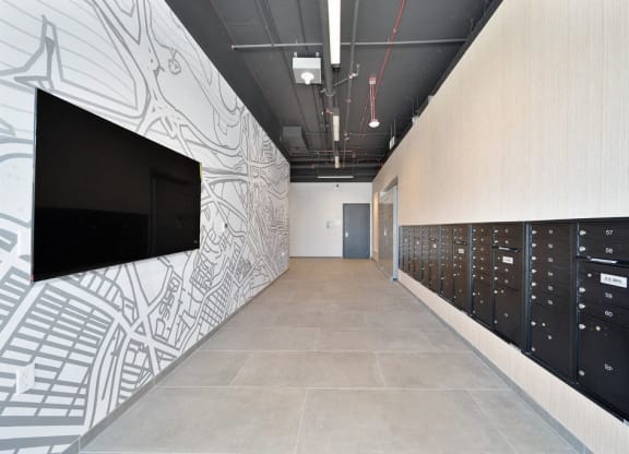 a hallway with lockers and a television on the wall