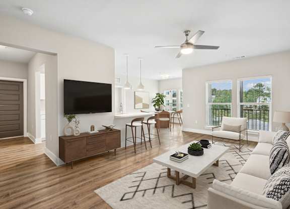 A2 A living room with a white couch, a wooden coffee table, and a flat-screen TV.