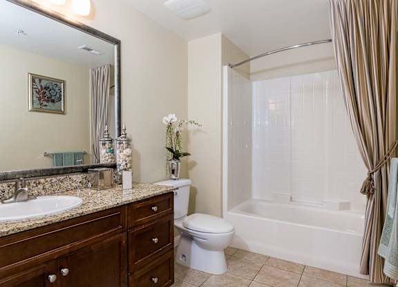 A bathroom with a toilet, sink, and bathtub.