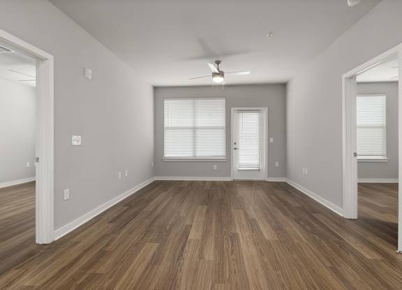 A room with wooden floors and white walls.