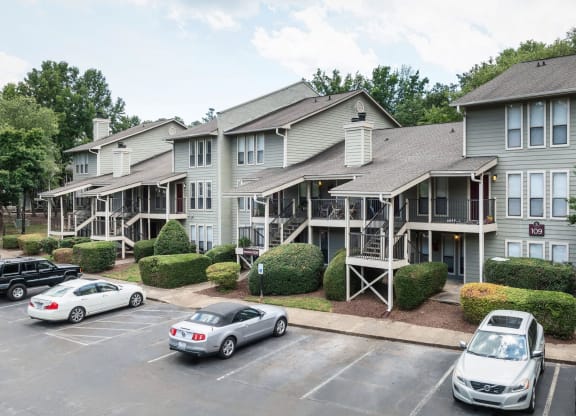 the apartment building with cars parked in front of it