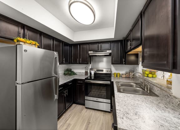 a kitchen with stainless steel appliances and marble counter tops