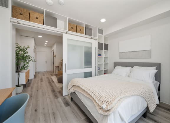a bedroom with a bed and a white bunk bed