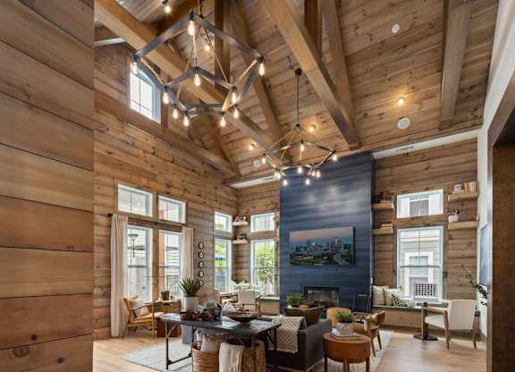 A wooden house with a large living room and a fireplace.