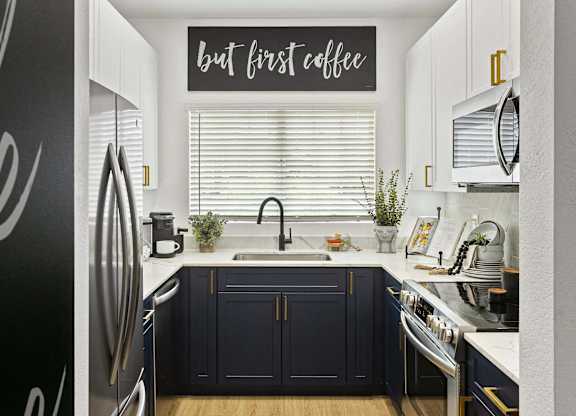 A kitchen with a sign that says "but first coffee".