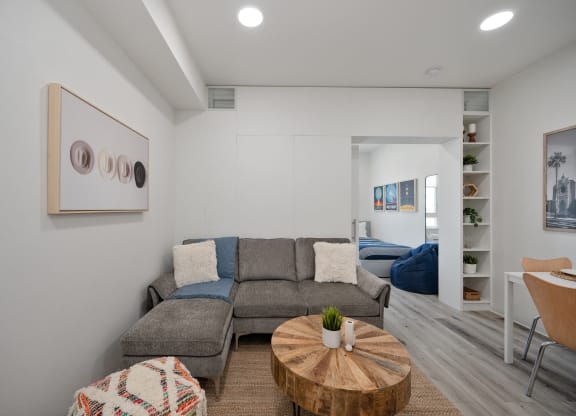 a living room with a gray couch and a coffee table