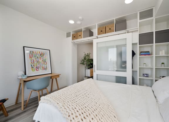 a bedroom with a large bed and a white closet