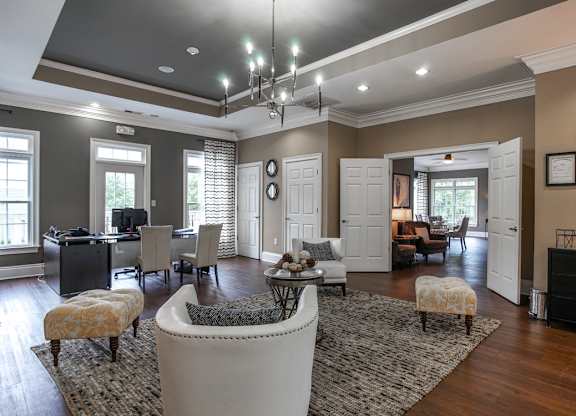 A living room with a white sofa and a rug.