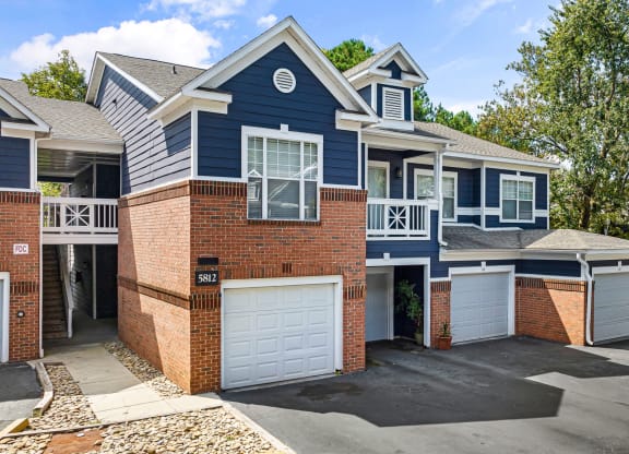 a blue and brick house with two garage doors at Mariners Crossing, North Carolina, 27612