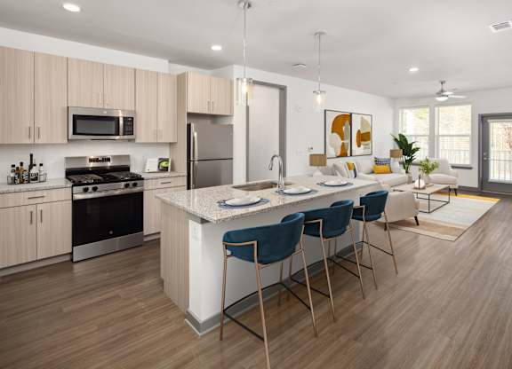 A modern kitchen with a bar area and a dining table.