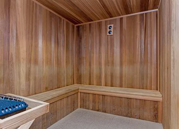 A sauna with a bench and a light switch.