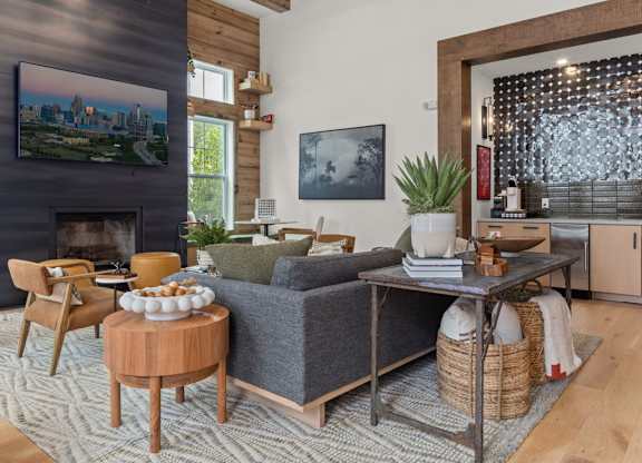 A living room with a grey couch and wooden floors.