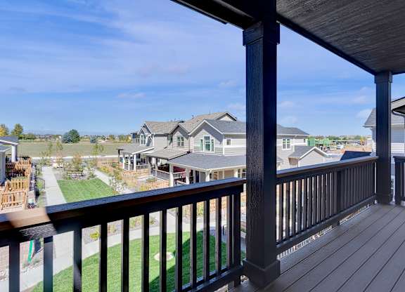 the view from the deck of a home with a yard and houses
