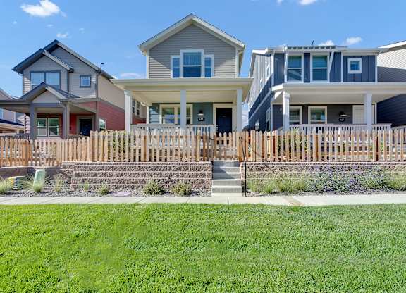 a row of houses with a sidewalk in front of them