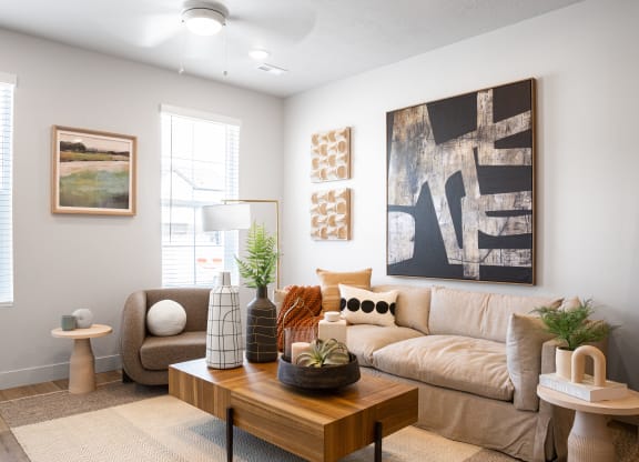 a living room with a beige couch and a wooden coffee table