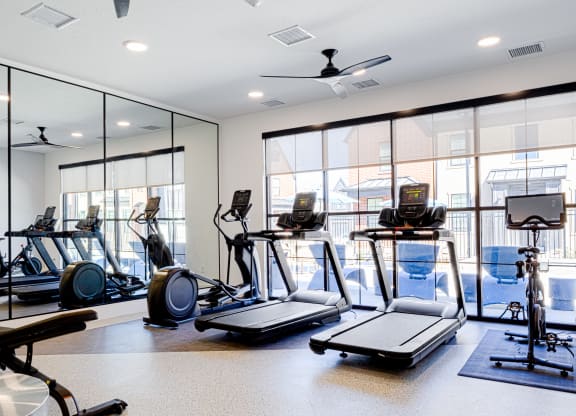 a gym with treadmills and other exercise equipment