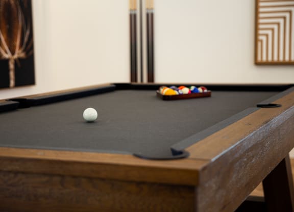a pool table in a room with a billiard ball on it