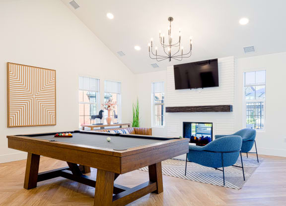 the preserve at ballantyne commons pool table and living room with fireplace