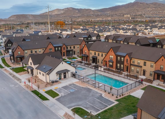 an aerial view of an apartment complex with a swimming pool